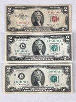 Front view of all three $2 bills: 1953 red seal on top, two 1976 green seals below