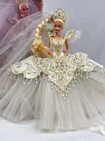 Full view of Empress Bride Barbie in gown, box background partially visible