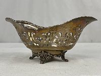 Side view showing pierced sides, footed base, overall form