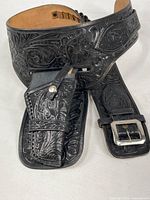 Overall view of tooled leather gun belt with attached holster