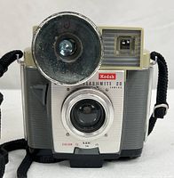 Front view of Kodak Brownie Flashmite 20 camera with flash and strap