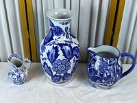 Front view of all three blue and white ceramic pieces