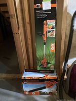 Both boxed items: tall box for trimmer/edger, smaller box for blower