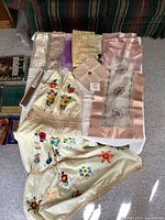 Lot overview showing dress, linens, fan, lace, gloves