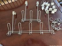 All items laid out: two over-door hangers and both sets of shower hooks