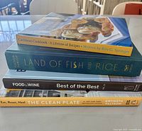 Stack of all four cookbooks showing spines and titles