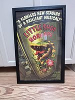 Framed Little Shop of Horrors poster standing upright