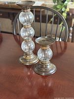 Pair of bronze-tone candlesticks on table