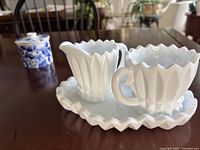Full view of milk glass creamer, sugar, tray with Portmeirion jam pot in background