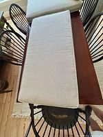 Top view of two cushions showing fabric and piping