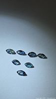 Seven marquise blue sapphires on neutral background