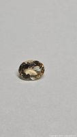 Oval faceted champagne morganite loose stone on neutral background
