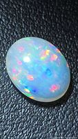 Top view of oval opal showing multicolor play-of-color