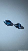 Two pear-cut deep blue tanzanites front view