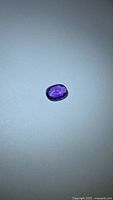 Oval purple sapphire on neutral background