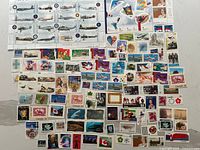 Entire lot showing full pane of aircraft stamps and large assortment of singles and blocks