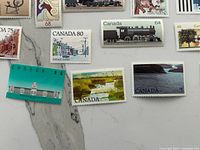 Overview of assorted Canadian stamps showing $5 Parliament, 55¢ landscape, locomotive, 80¢ streetcar