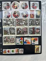 Binder page showing circular Mountie stamps, animal art 48¢ stamps, $1.25 stamp, maple leaf definitives