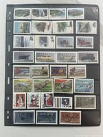 First stock page with landscape, automobile, dinosaur and sports stamps