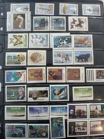 First stock page with multiple rows of mint Canadian stamps showing various themes and denominations