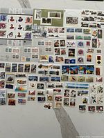 Entire assortment of mint Canada stamps spread out to show quantity and variety