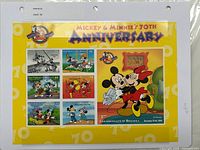 Full view of Dominica Mickey & Minnie 70th Anniversary stamp sheet inside protective page