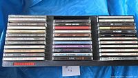 Open Definitive storage case showing two rows of 36 CD jewel cases
