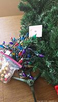 Artificial tree branches, stand, bundled lights, bag of miniature bulbs
