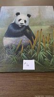 Front view of the panda bear canvas showing full artwork and size reference card