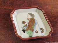 oblique view of square Imari dish showing painted figure and border