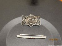 Front view of both pieces showing filigree brooch above and cloisonné bar pin below