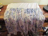 Bed skirt draped to show gathering and fabric design