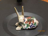 Front three-quarter view of cloisonné rabbit figurine