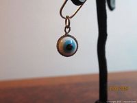 Front view showing evil eye design and metal bezel