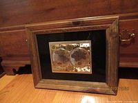 Entire framed world map print resting against furniture