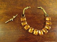 Front view of necklace and bar pin