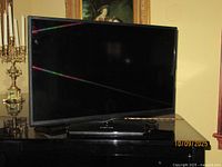 Front view of Sceptre 32" flat screen TV on swivel base
