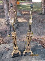 Full view of both black column lamps on outdoor surface