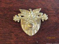 Front view showing crest design and motto