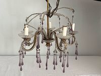 Overall view of five-arm chandelier with purple crystals