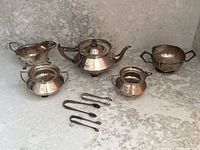 Group view of all hollowware pieces and tongs