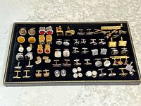 Full tray showing entire assortment of cufflinks, tie clips and studs