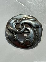 Front view of Georg Jensen sterling brooch showing full circular leaf motif