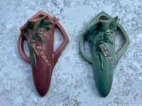 Front view of both wall pocket vases showing colors and floral motif