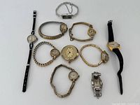 Group shot of all ten watches arranged on white background