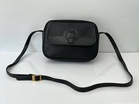 Front view showing flap, buckle accent and full strap