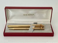 Open presentation box showing both gold-plated pens secured inside