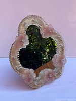 Front view showing mirror and floral glass frame