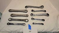 Eight ratcheting box wrenches laid out to show overall assortment