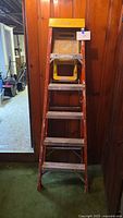 Front view of Werner orange fiberglass 6 ft step ladder
